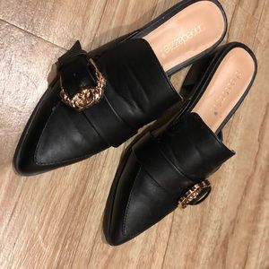 Black mules/loafers with gold buckle